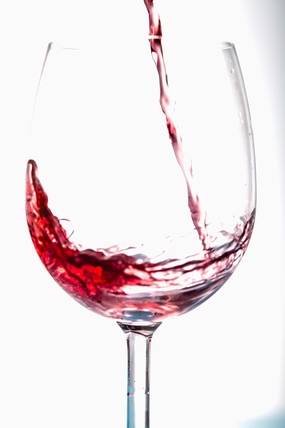 Pouring wine into the glasses, white background, isolated - Photo, Image