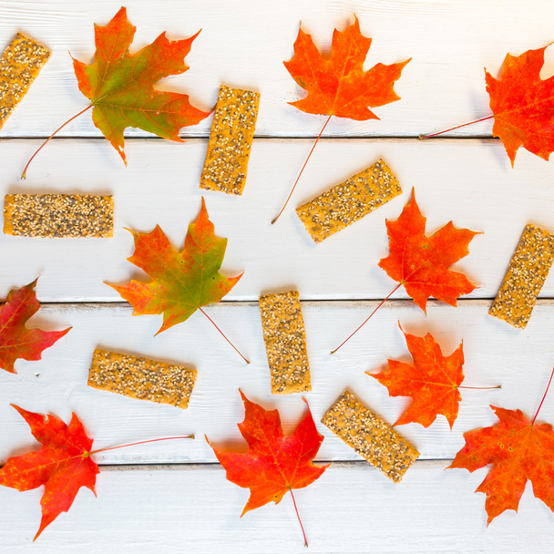 Pattern of seeds  flatbreads and  autumn maple leaves on white w - Φωτογραφία, εικόνα