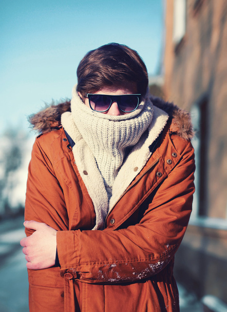 Fashion portrait hipster man freezes hides his head and warms bo - Zdjęcie, obraz