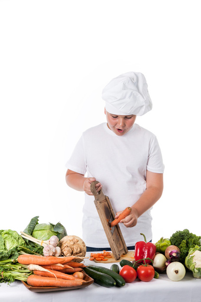 One little boy as chef cook making salad, cooking with vegetable - Photo, Image