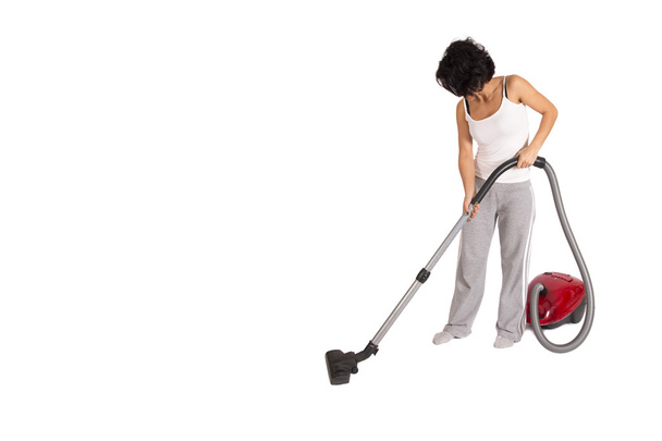 junge Frau putzt Haus mit Staubsauger - Foto, Bild