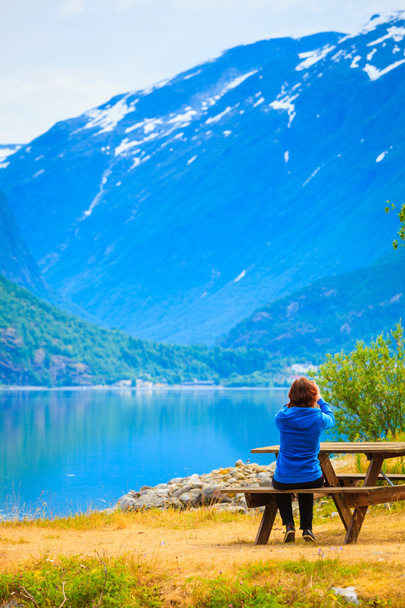 Tourist taking photo at norwegian fjord - Фото, зображення