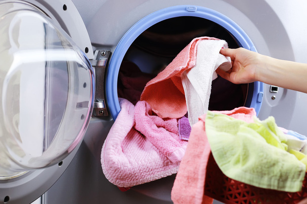 put cloth in washer - Photo, Image