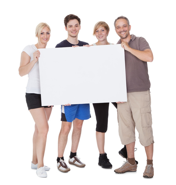 Happy family holding blank placard - Fotoğraf, Görsel