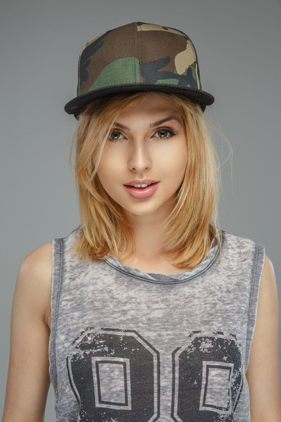 Позитивна блондинка в військовій шапці
. - Фото, зображення