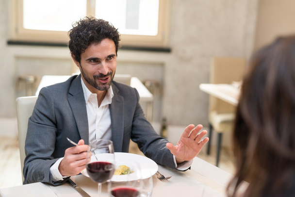 Man speaking while eating at restaurant - Foto, Imagen