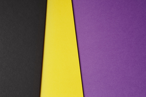 Colored carboards background in black yellow purple tone. Copy s - Zdjęcie, obraz