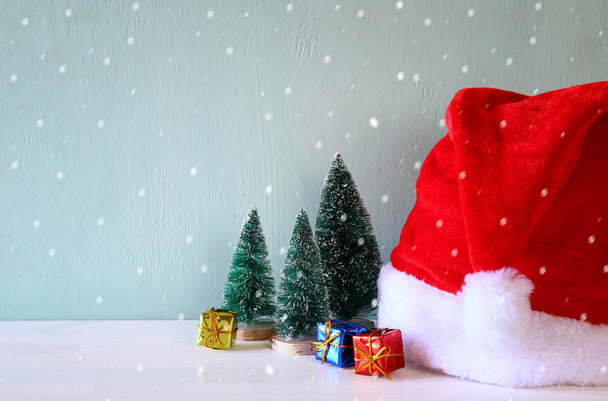Kép a karácsonyfa mellett santa kalap. - Fotó, kép