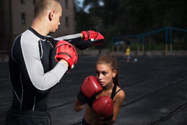 personal trainer coach men and women engaged in boxing at the stadium - Photo, Image