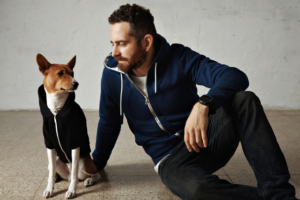 Man and dog in matching hoodies - Zdjęcie, obraz