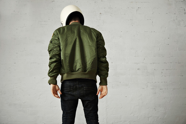 Man in green bomber jacket with helmet - Valokuva, kuva