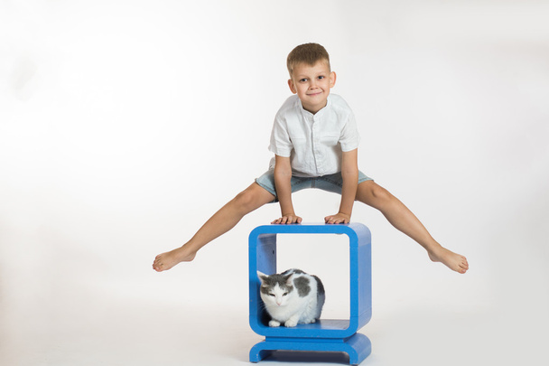 Boy makes gymnastic exercise  - Фото, изображение