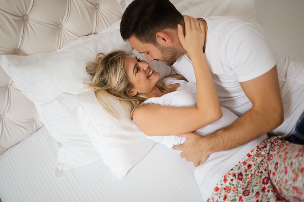 Passionate couple foreplay in bed - Fotoğraf, Görsel