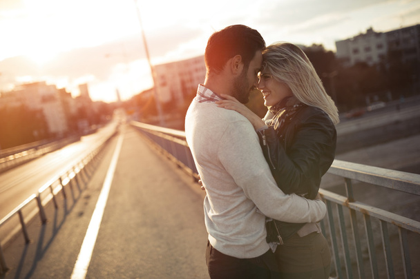 Romantic couple in love enjoying sunset - Foto, afbeelding