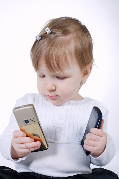 little funny girl with two mobile phones - Foto, imagen