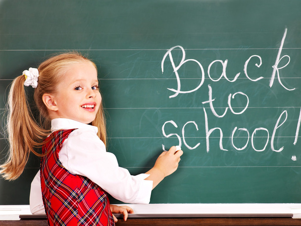 Child writting on blackboard. - Photo, Image