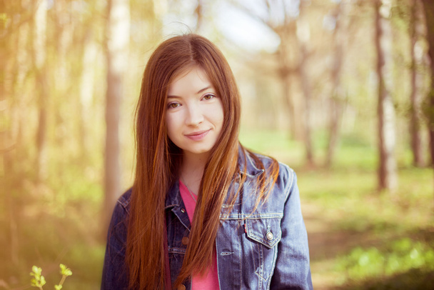 Portrait of a girl with long straight brown hair, which fly in t - 写真・画像