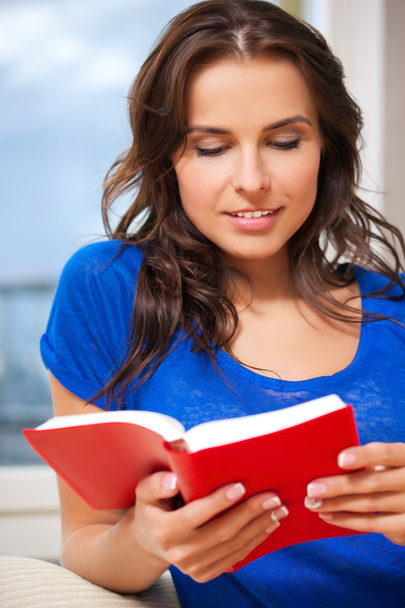 Happy and smiling woman with book - Photo, image