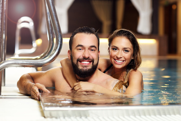 Happy couple relaxing in pool spa - 写真・画像