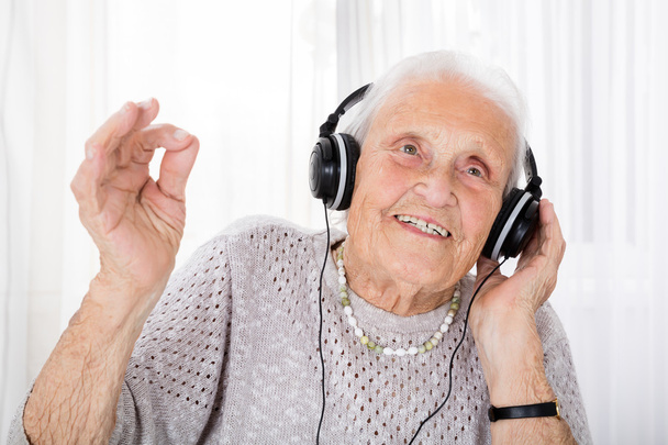 Senior Woman Enjoying Music With Headphone - Fotó, kép