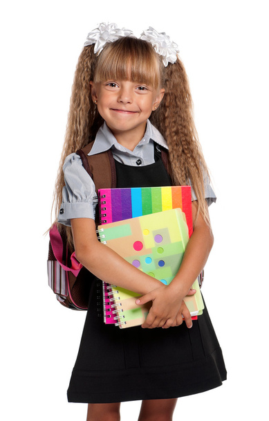 Little girl with exercise books - Foto, afbeelding