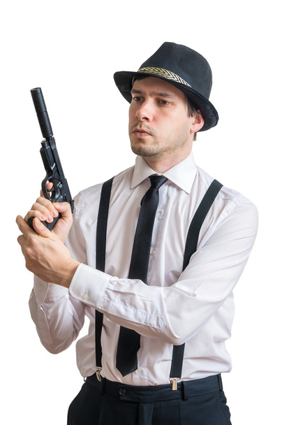 Young mafia man or detective holds gun in hands. Isolated on white background. - Foto, imagen