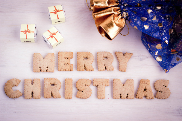 Chocolate gifts and biscuit-made lettering "Merry Christmas". Toned image. - Fotó, kép