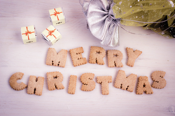 Chocolate gifts and biscuit-made lettering "Merry Christmas". Toned image. - Фото, зображення