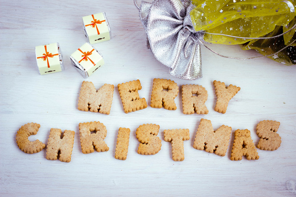 Chocolate gifts and biscuit-made lettering "Merry Christmas". Toned image. - Fotoğraf, Görsel