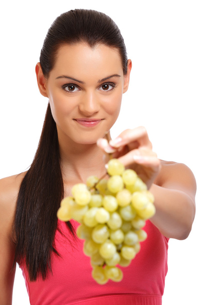 Closeup portrait of a woman offering grapes - Foto, Imagen