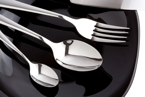 silver fork, knife and spoon as utensils on plate - Foto, imagen