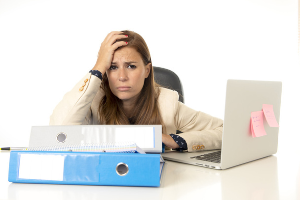 businesswoman suffering stress at office computer desk looking worried depressed and overwhelmed - Photo, Image