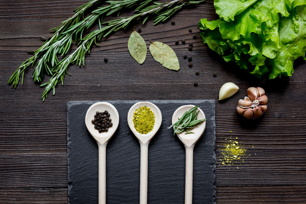 spices and fresh herbs on wooden table top view - Foto, immagini