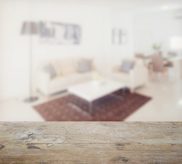wooden table top with blur of modern living room interior - Foto, Imagen
