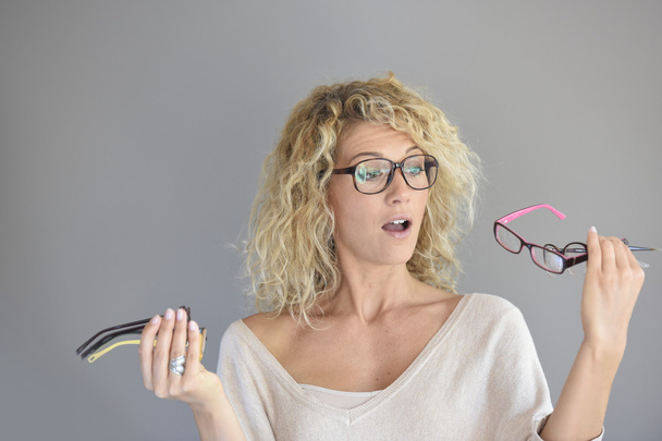 woman  choosing between different eyeglasses - Foto, Imagen