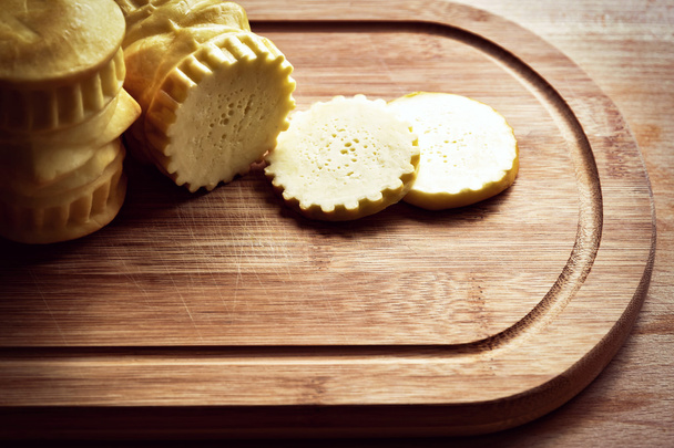 traditional smoked cheese on a board - Фото, зображення