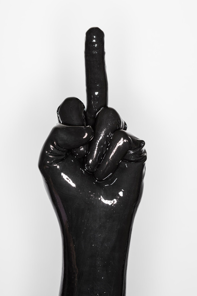 gesture of a hand wearing a black latex glove. middle finger - Zdjęcie, obraz