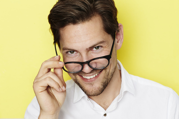 Man peering over spectacles - Fotoğraf, Görsel