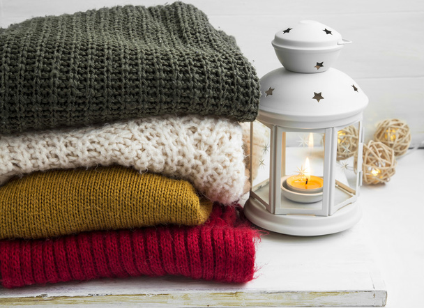 Winter cozy woolen sweaters and candle lantern - Photo, Image