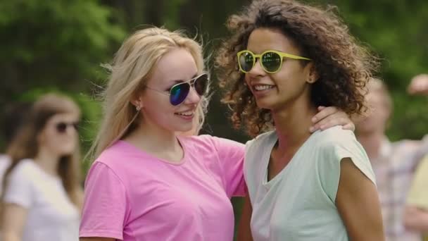 Jovens mulheres bonitas em óculos de sol amarelos dançando com amigos, relaxamento no parque
 - Filmagem, Vídeo