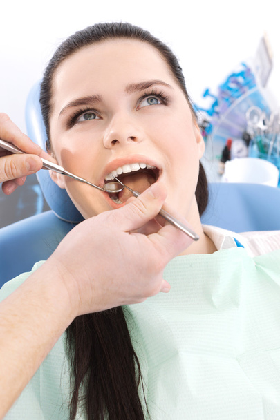 Dentist examines the oral cavity of the patient - Fotó, kép