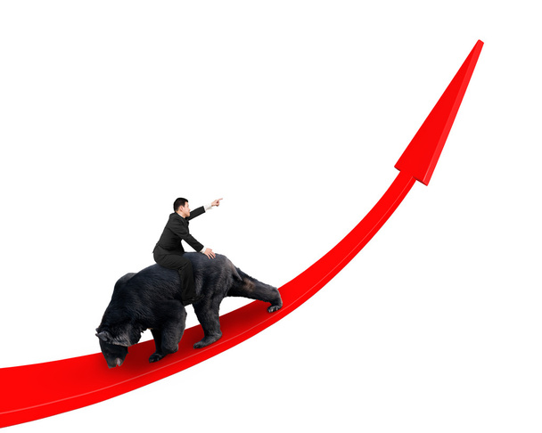 Biznesmen jazda czarny niedźwiedź na czerwona strzałka w górę linii trendu - Zdjęcie, obraz