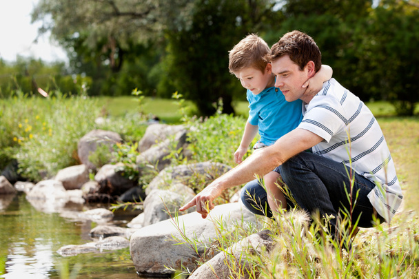 Fashing and Son Playing Near Lake - Фото, изображение
