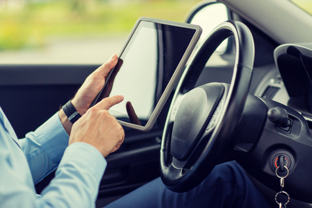 close up of young man with tablet pc driving car - Photo, Image