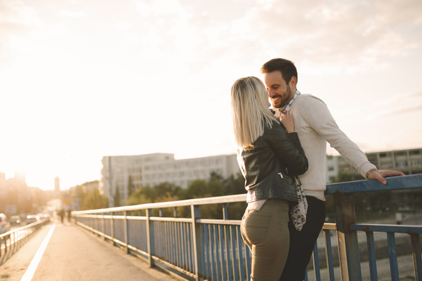 Couple kissing dating on bridge - Photo, image
