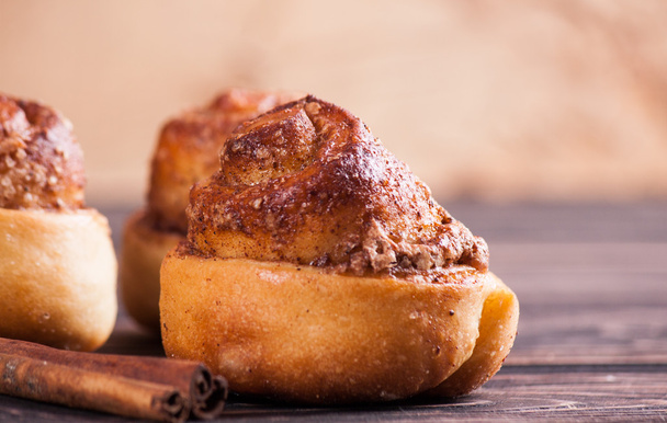 Cinnamon bun on wood background - Photo, Image