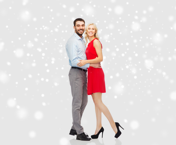 happy couple hugging over snow background - Φωτογραφία, εικόνα