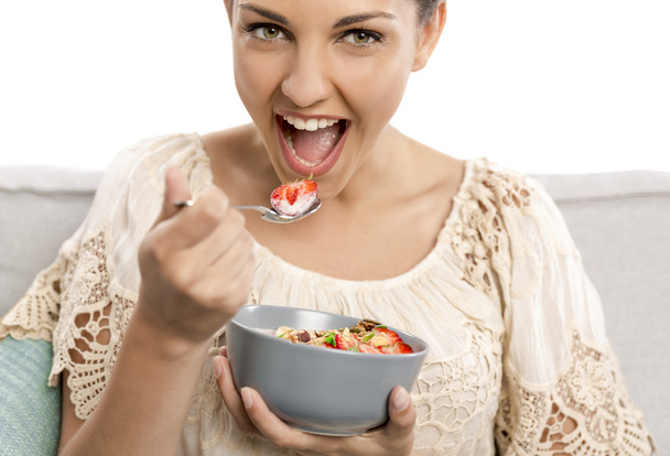 woman in beige blouse eating food  - Zdjęcie, obraz