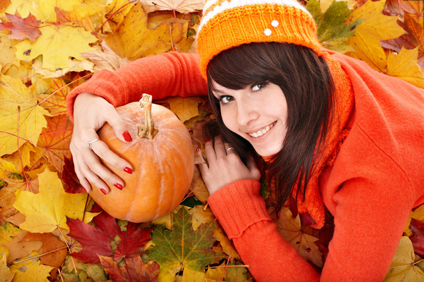 Girl with pumpkin on autumn leaves. - Photo, Image