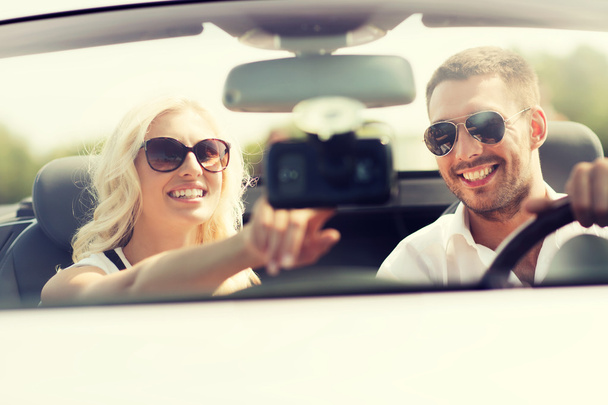 happy couple usin gps navigation system in car - 写真・画像